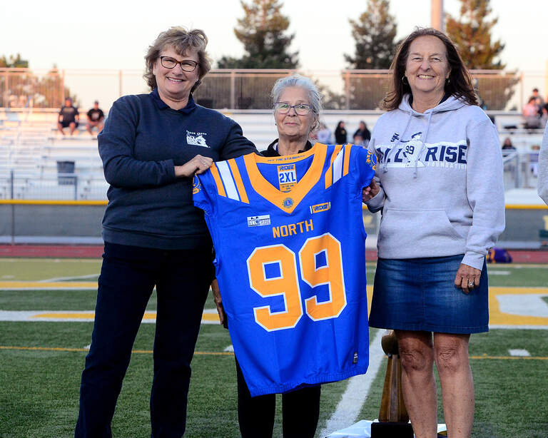 Patty Judge accepts a blue North jersey from the Lions Club on behalf of Aaron Judge's All Rise Foundation